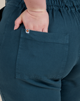 Close up of Ashley's hand in the back pocket of Short Sleeve Jumpsuit in Lagoon
