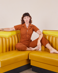 Alex is wearing Short Sleeve Jumpsuit in Burnt Terracotta