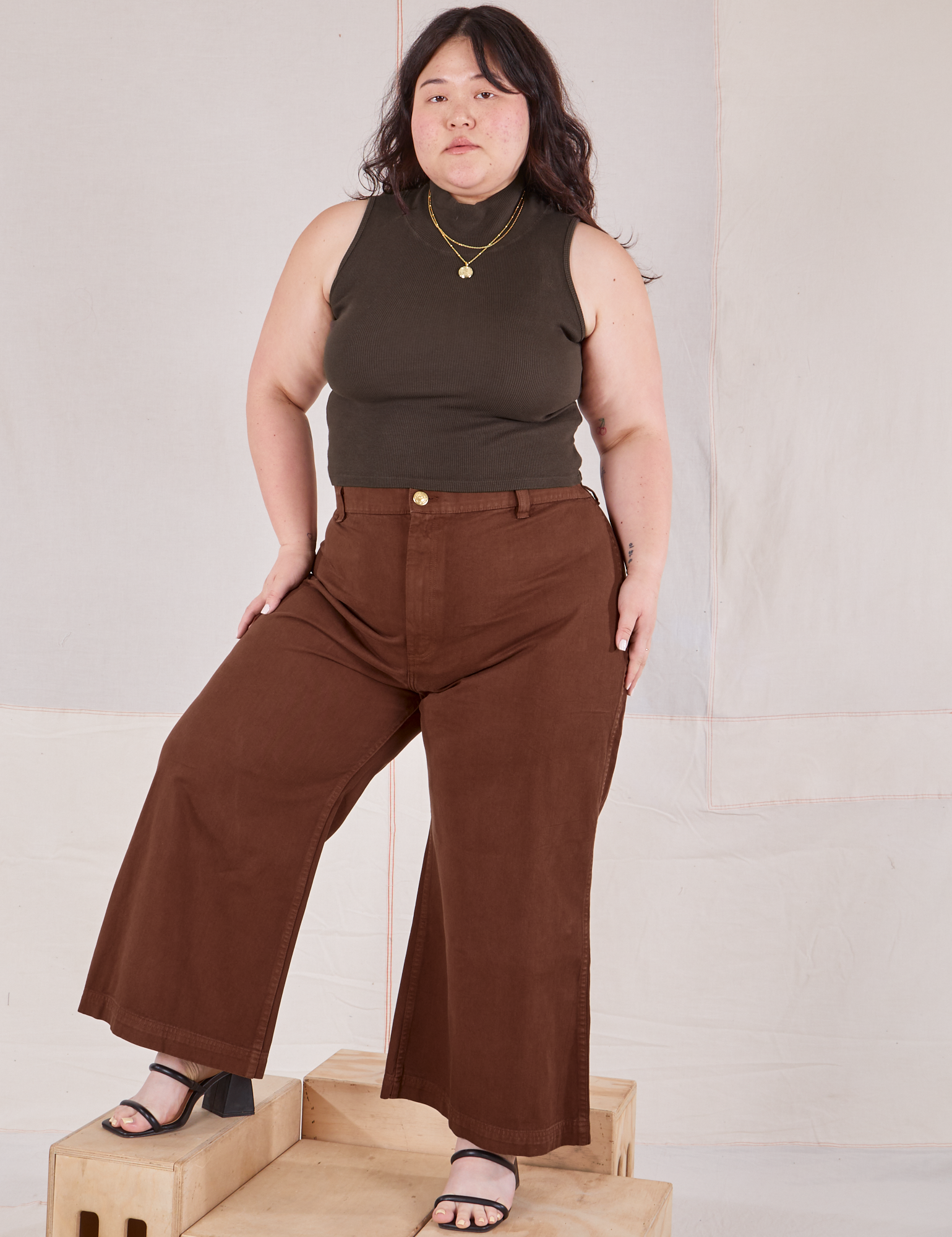 Ashley is wearing Sleeveless Essential Turtleneck in Espresso Brown and fudgesicle brown Bell Bottoms