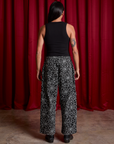 Back view of Drop Pocket Cargo Pants in Spider Webs and black Cropped Tank on Anthony