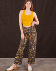 Scarlett is 5'9" and wearing XS Marble Splatter Work Pants in Espresso Brown paired with mustard yellow Tank Top