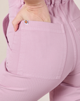 Close up of Alex's hand in the back pocket of Short Sleeve Jumpsuit in Lilac