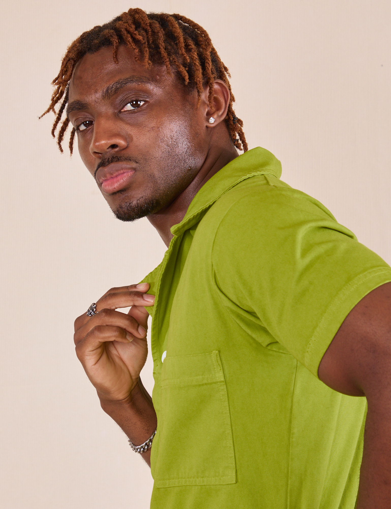 Short Sleeve Jumpsuit in Gross Green side shoulder close up on Issac