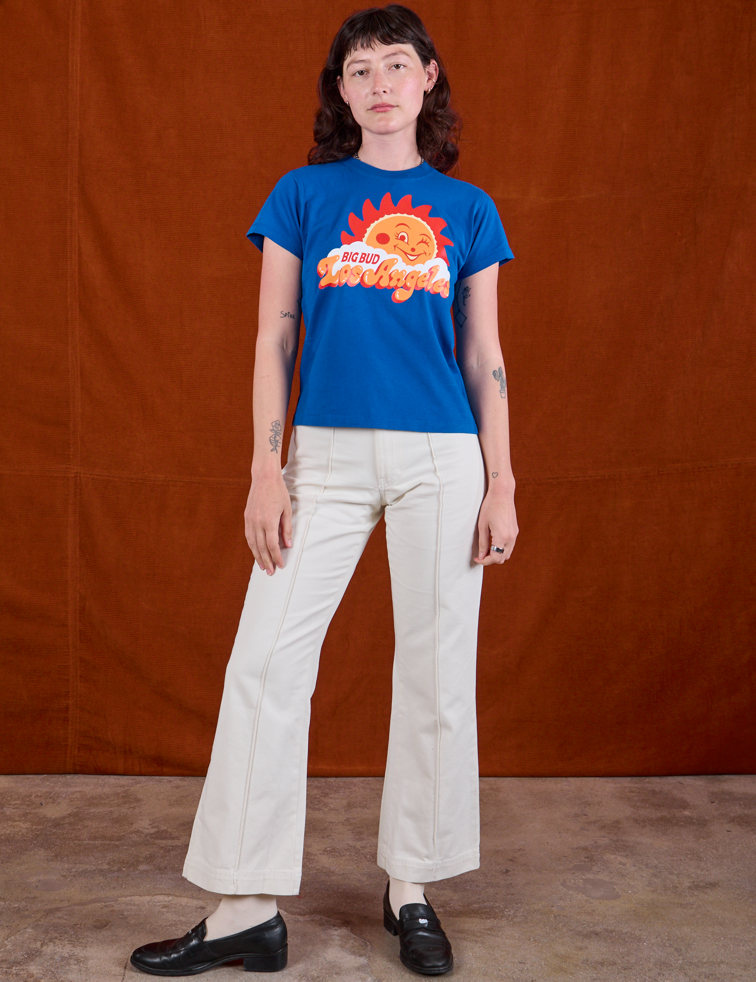 Alex is wearing Sunny Los Angeles Tourist Tee and vintage tee off-white Western Pants
