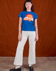 Alex is wearing Sunny Los Angeles Tourist Tee and vintage tee off-white Western Pants