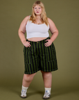 Juliet is 5’7” and wearing 2XL Longline Work Shorts in Evergreen paired with a Cropped Tank in Vintage Tee White