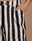 Close up of Anthony's hand in the front pocket of Black Stripe Work Pants in White