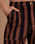 Close up of Anthony's hand in the front pocket of Black Stripe Work Pants in Fudgesicle Brown