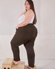 Angled back view of Rolled Cuff Sweat Pants in Espresso Brown and Cropped Tank in vintage tee off-white on Marielena