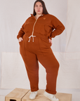 Marielena is 5'8" and wearing L Cropped Zip Hoodie in Burnt Terracotta paired with matching Rolled Cuff Sweat Pants