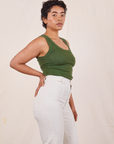 Side view of Tank Top in Dark Emerald Green and vintage off-white Western Pants on Mika
