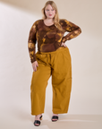 Juliet is wearing Long Sleeve Baby Tee in Honey Brown and spicy mustard Drop Pocket Cargo Pants