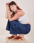 Alex is wearing Indigo Wide Leg Trousers in Dark Wash and vintage off-white Cami