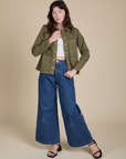 Alex is wearing Denim Work Jacket in Surplus Green and dark wash Indigo Wide Leg Trousers