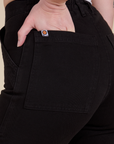 Close up of Alex's hand in the back pocket of Work Pants in Basic Black
