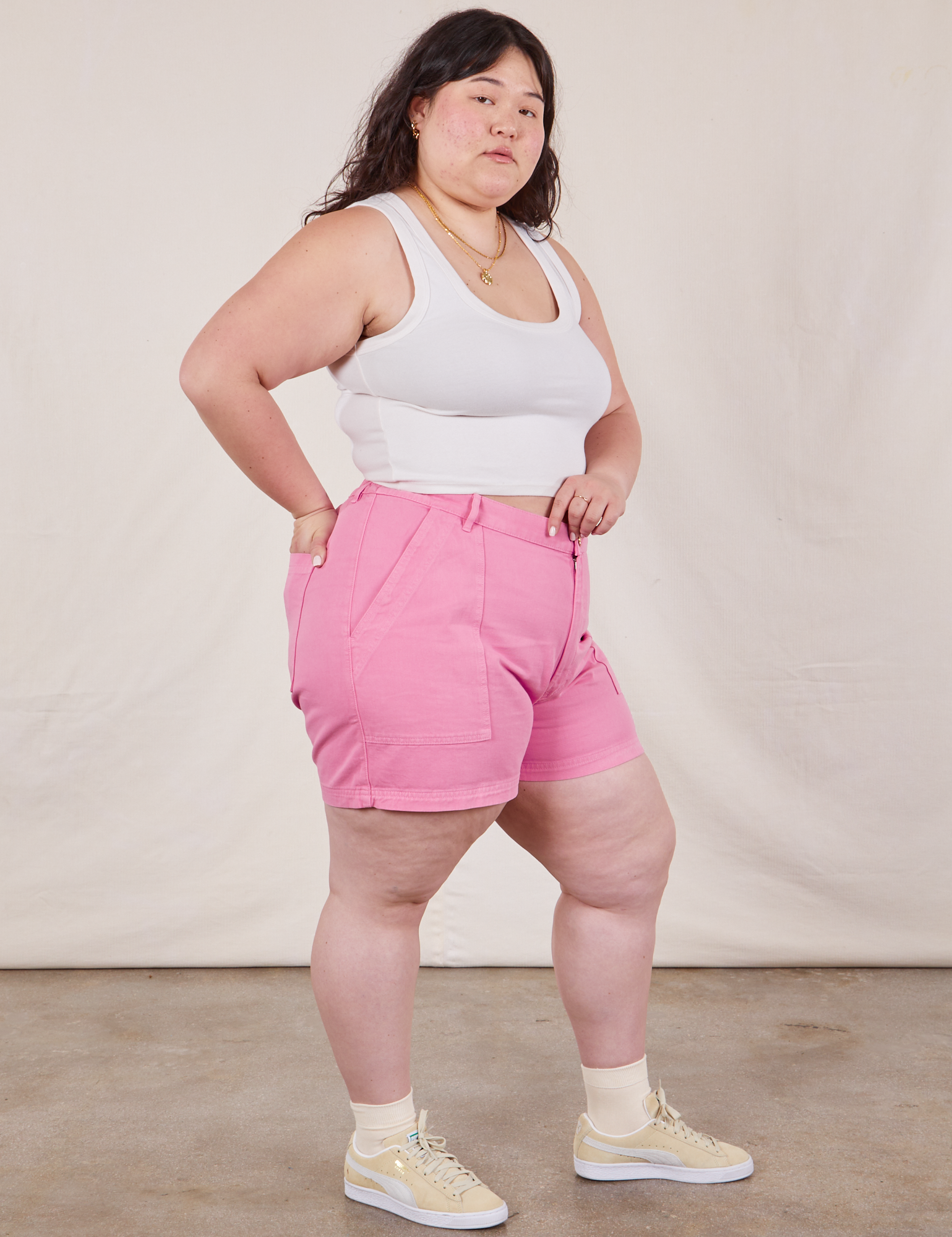 Angled front view of Classic Work Shorts in Bubblegum Pink and Cropped Tank Top in vintage tee off-white on Ashley