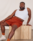 Elijah is wearing Classic Work Shorts in Paprika and Cropped Tank Top in vintage tee off-white
