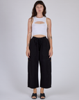 Alex is wearing the Vintage Tee White Porthole Tank with Black Cargo Pants