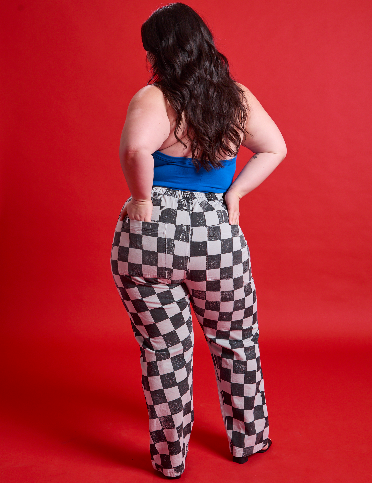 Back view of Checkerboard Work Pants in Black/White and halter top Royal Blue on Ashley