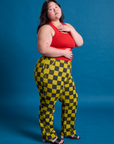 Side view of Checkerboard Work Pants in Yellow/Black and mustang red Tank Top on Ashley