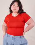 Ashley is 5'7" and wearing L Baby Tee in Mustang Red