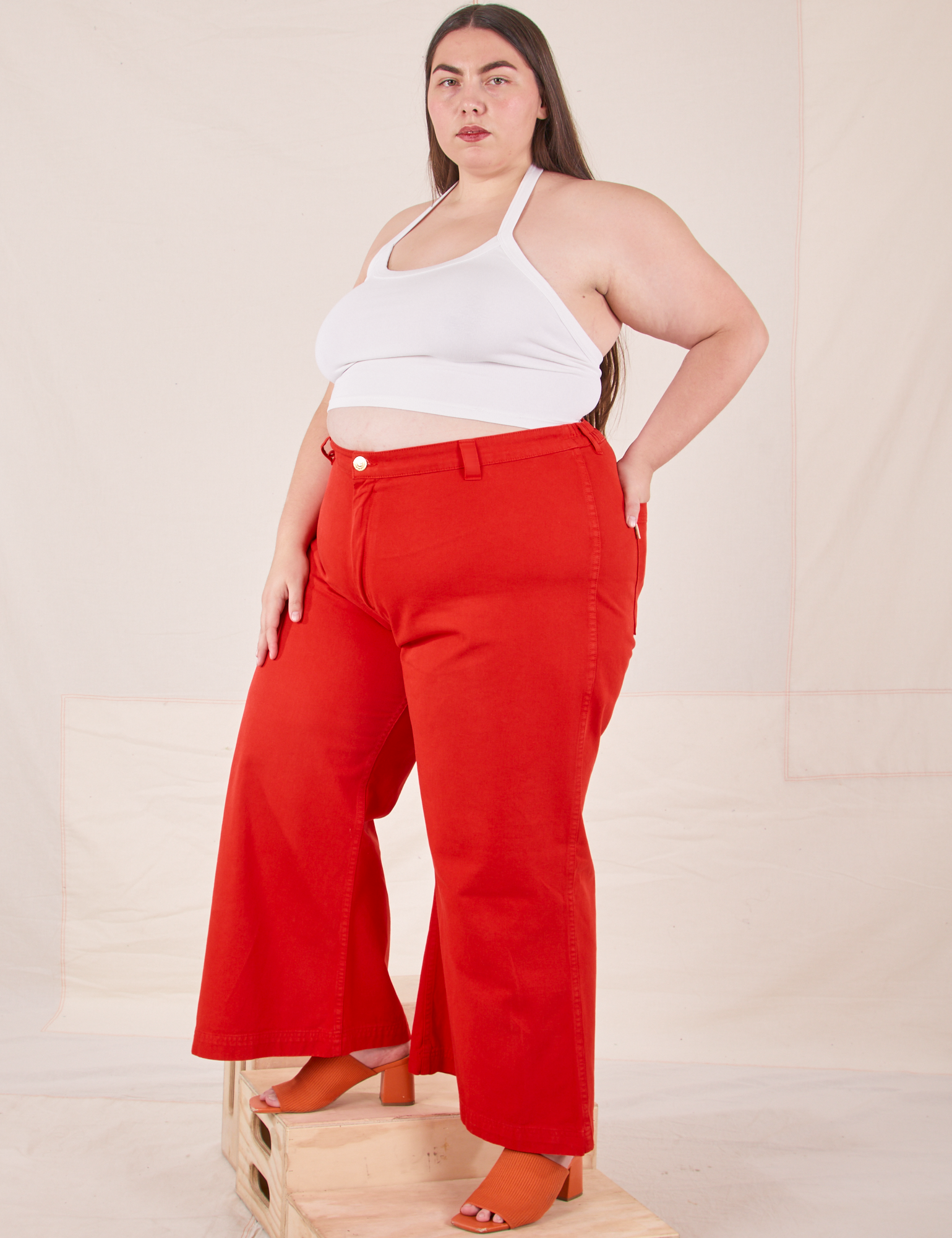 Angled view of Bell Bottoms in Mustang Red and Halter Top in vintage tee off-white on Marielena