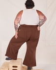 Back view of Bell Bottoms in Fudgesicle Brown and Tank Top in vintage tee off-white on Sam