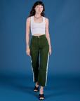 Alex is wearing Painted Work Pants in Evergreen and vintage tee white Cropped Tank