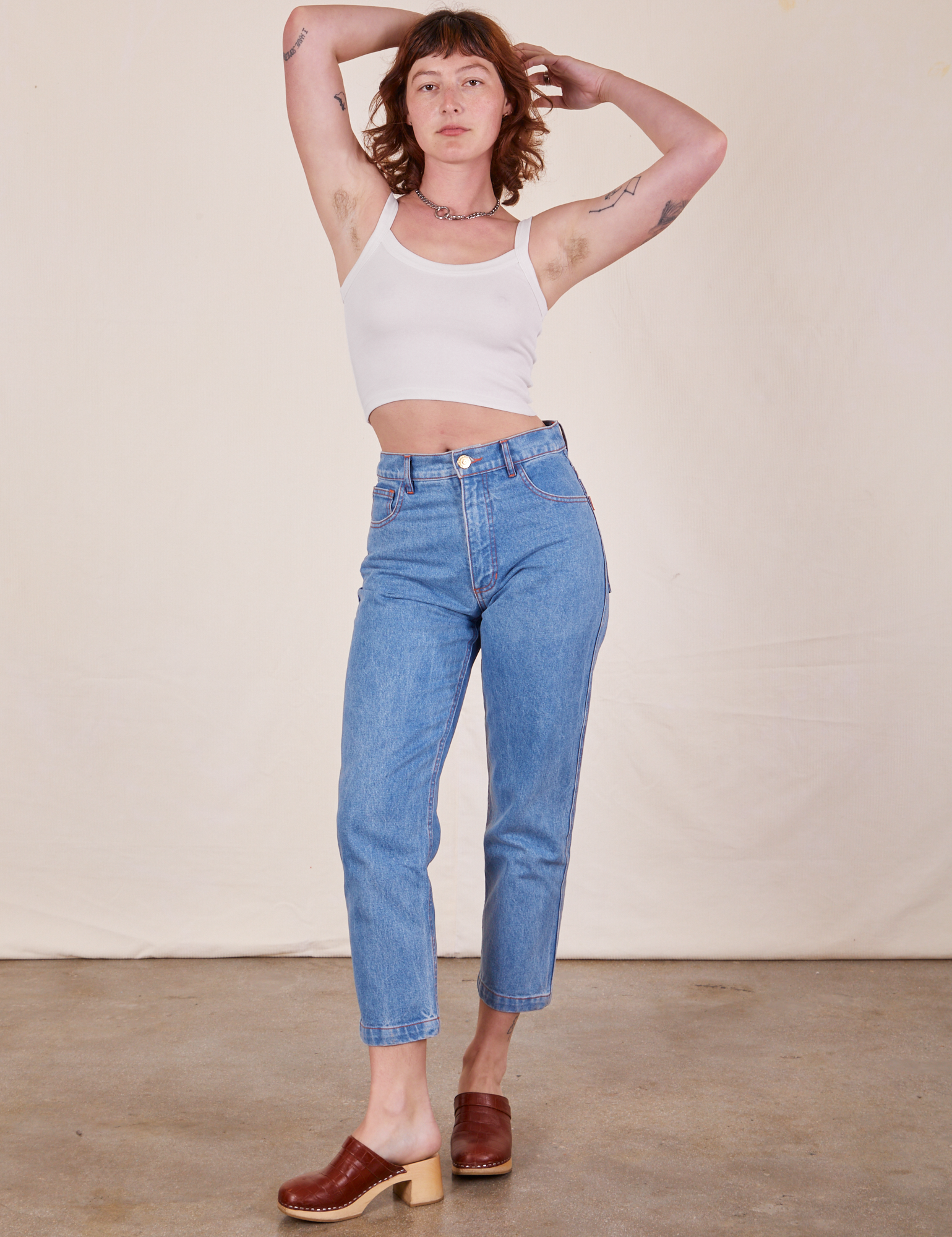 Alex is wearing Cropped Cami in Vintage Tee Off-White and light wash Frontier Jeans