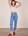 Alex is wearing Cropped Cami in Vintage Tee Off-White and light wash Frontier Jeans
