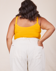 Back view of Cropped Cami in Sunshine Yellow and vintage tee off-white Western Pants worn by Alicia. She has her left hand in the back pant pocket.