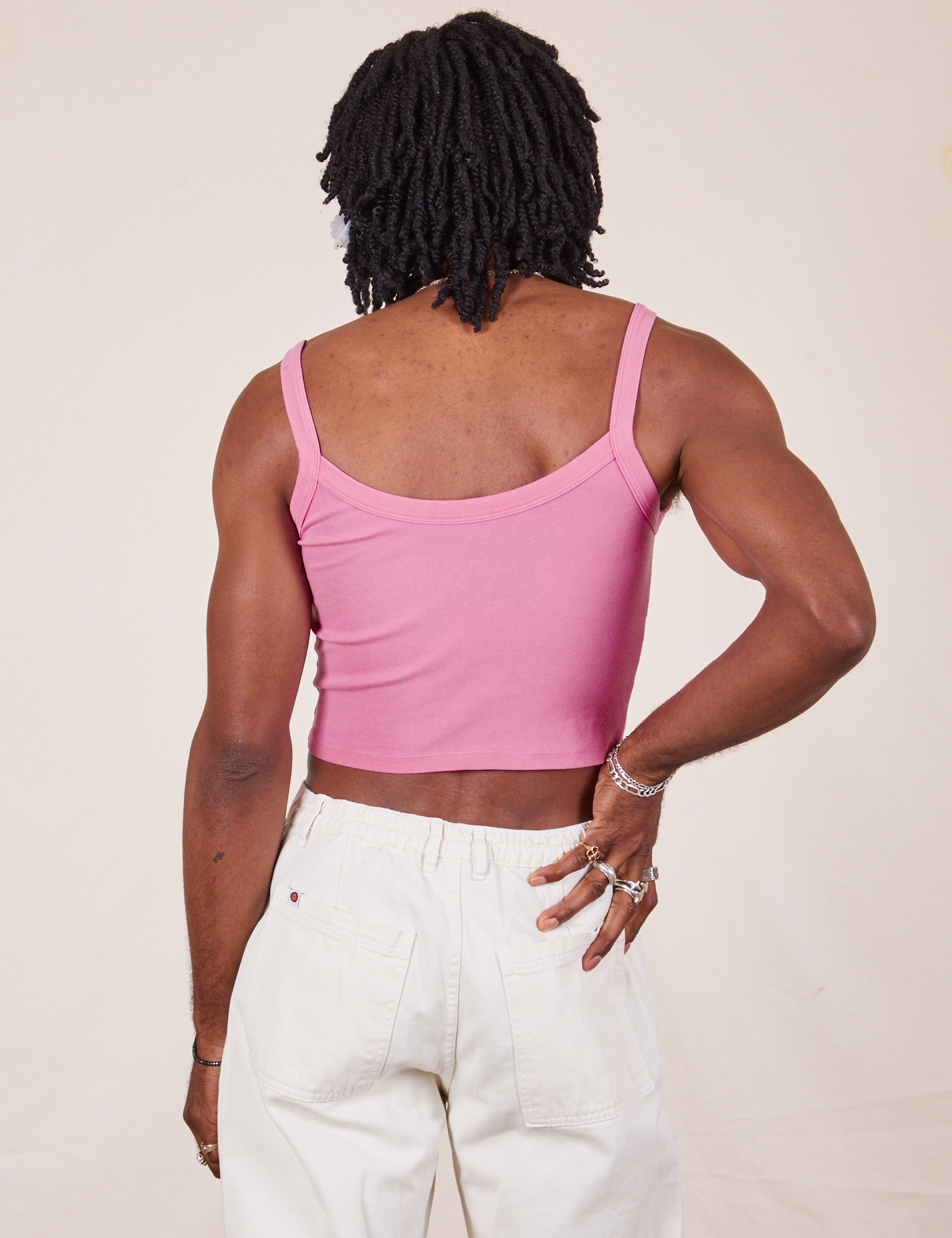 Back view of Cropped Cami in Bubblegum Pink and vintage tee off-white Western Pants worn by Jerrod