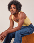 Jerrod is wearing Cropped Cami in Butter Yellow and dark wash Carpenter Jeans