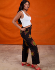 Side view of Paintstamped Work Pants in Explosion and Cropped Tank in Vintage Tee White on Kandia