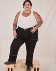 Sam is 5'10" and wearing 3XL Carpenter Jeans in Black and a Tank Top in vintage tee off-white