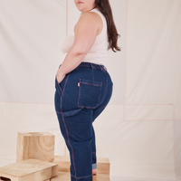 Side view of Carpenter Jeans in Dark Wash worn by Ashley