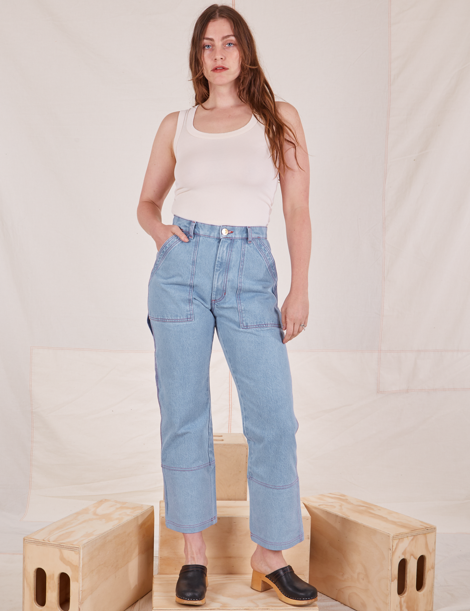 Allison is 5&#39;10&quot; and wearing S Carpenter Jeans in Light Wash paired with Tank Top in vintage tee off-white