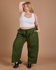 Juliet is 5’7” and wearing 1XL Drop Pocket Cargo Pants in Evergreen paired with a Cropped Tank in vintage tee white