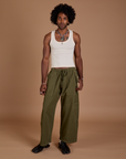 Jerrod is 6’3” and wearing M Drop Pocket Cargo Pants in Surplus Green paired with a Tank Top in vintage tee white
