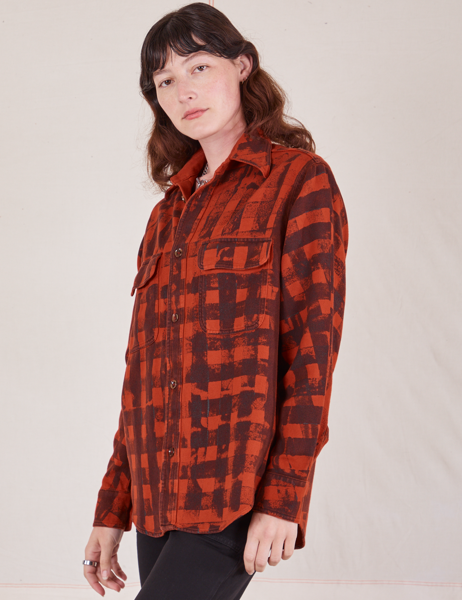 Angled view of Plaid Flannel Overshirt in Paprika on Alex