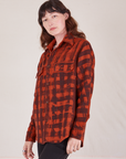 Angled view of Plaid Flannel Overshirt in Paprika on Alex