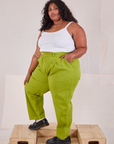 Angled front view of Heavyweight Trousers in Gross Green and Cami in vintage tee off-white on Morgan