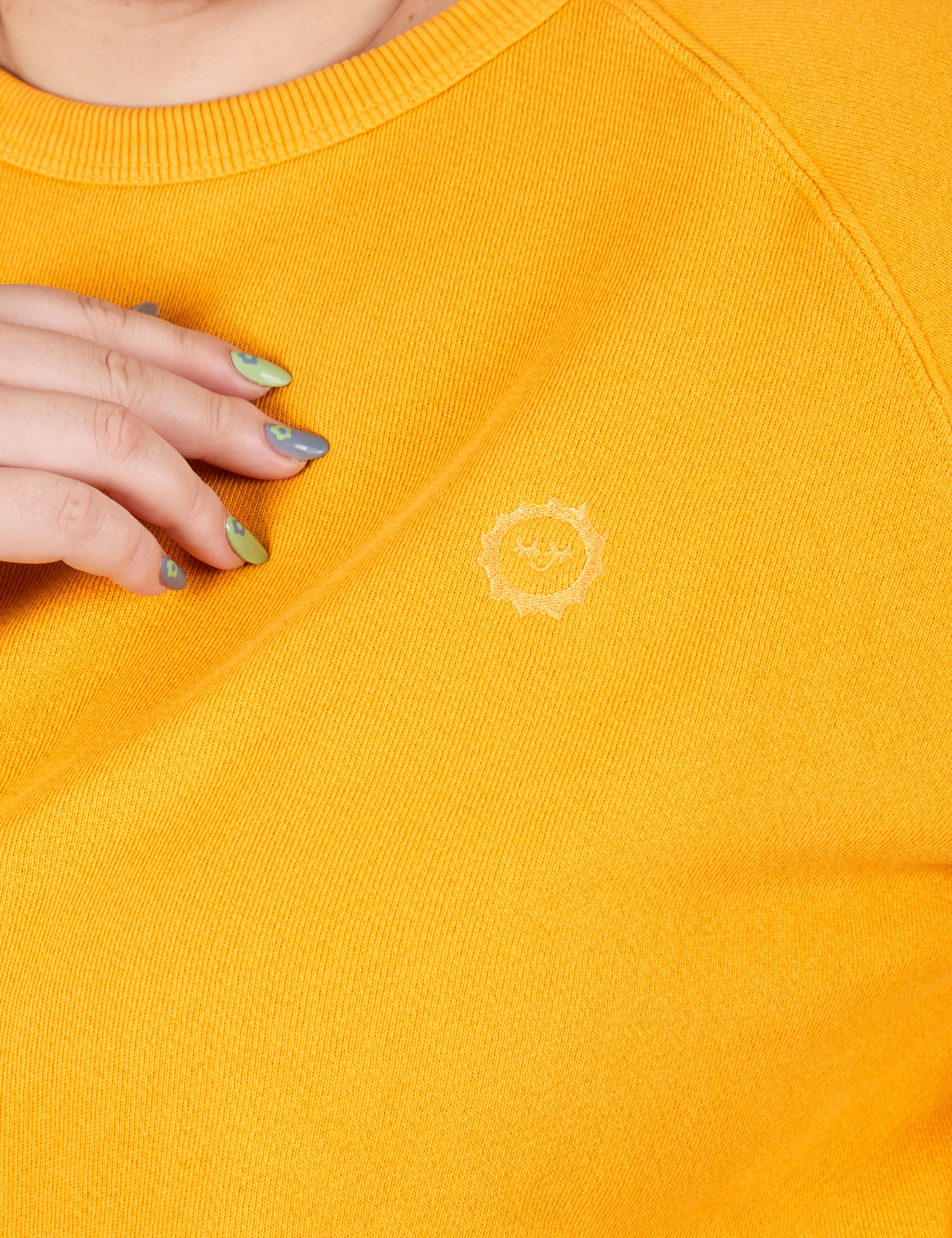 Heavyweight Crew in Mustard Yellow front close up on Ashley. Embroidered Sun Baby logo.