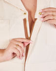 Heritage Short Sleeve Jumpsuit in Natural front zipper close up on Katie