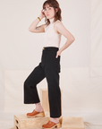Side view of Heritage Westerns in Basic Black and Sleeveless Turtleneck in vintage tee off-white worn by Hana