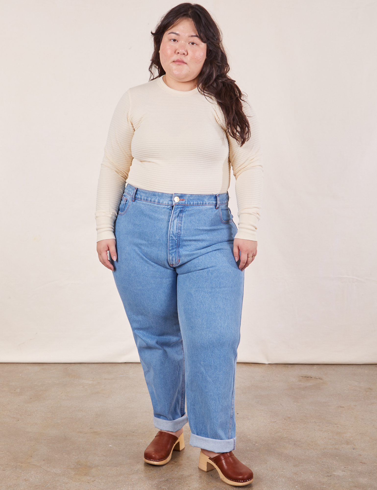 Ashley is wearing Honeycomb Thermal in Vintage Off-White tucked into light wash Frontier Jeans