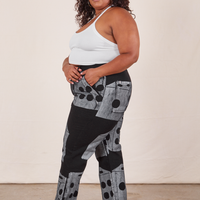 Side view of Icon Work Pants in Dice and vintage off-white Halter Top worn by Morgan