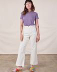 Alex is wearing Jr. Varsity Tee in Faded Grape tucked into vintage tee off-white Western Pants