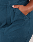 Short Sleeve Jumpsuit in Lagoon front pocket close up. Morgan has her hand in the pocket.