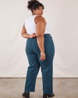Angled back view of Work Pants in Lagoon and vintage tee off-white Tank Top